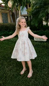 AI-generated Sorry I Lied trend step 2: the girl wears silver sandals with her floral dress