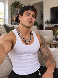 Example input photo used to generate the Nightwing AI demo: a man wearing a white tank top, backwards black cap and silver chain.